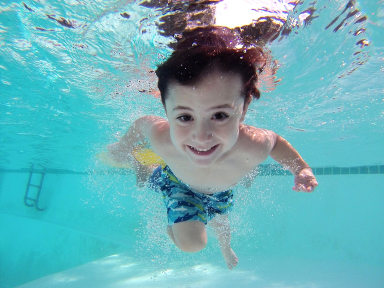 Little Boy Swimming in a Pool
